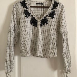 White and black plaid top with flower detail